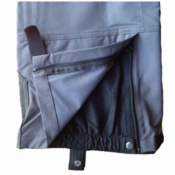 Gray waterproof pants with zipper and button.