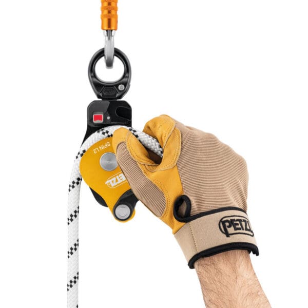 Hand using a Petzl Spin climbing device.