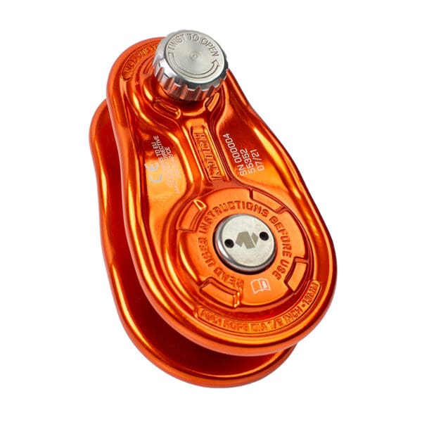 Orange climbing pulley with locking mechanism.